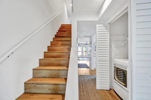 a view of entryway and hall with wooden floor