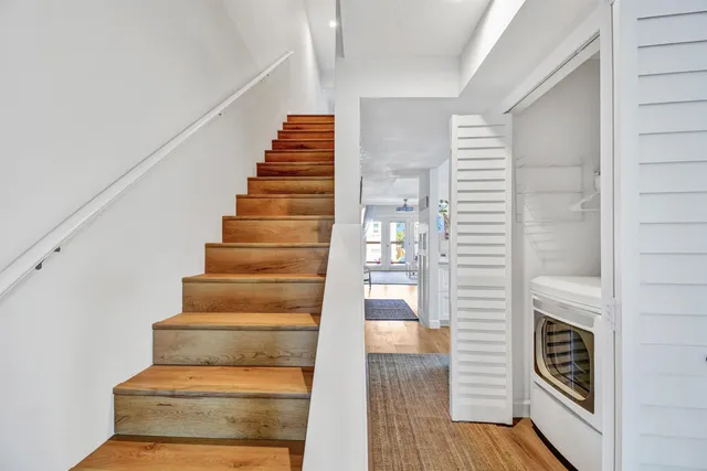 a view of entryway and hall with wooden floor