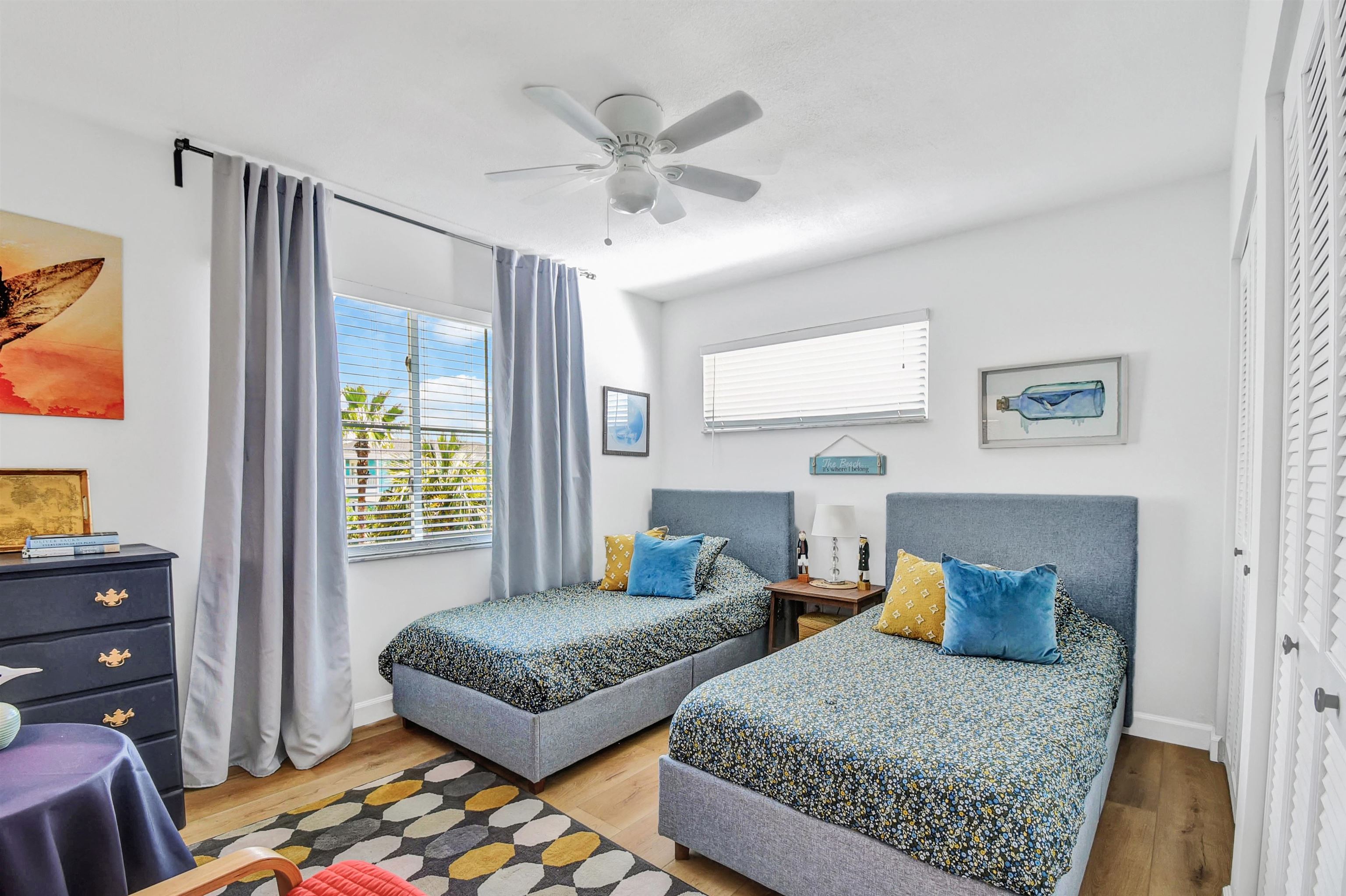 5703 Rudolph Avenue St. Augustine, FL 32080 - Photo 17 of 29 a bedroom with a large bed and a chandelier