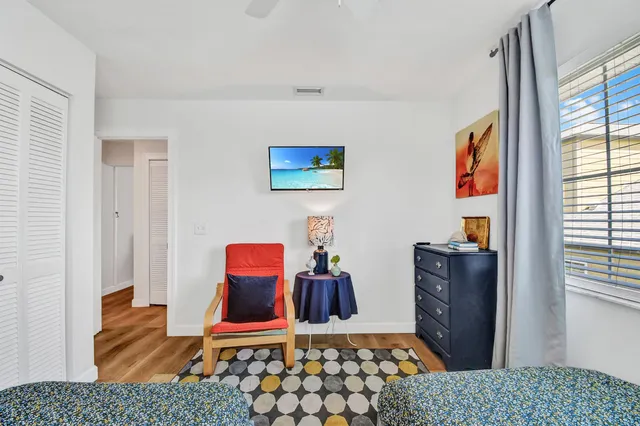 a bedroom with furniture and a window