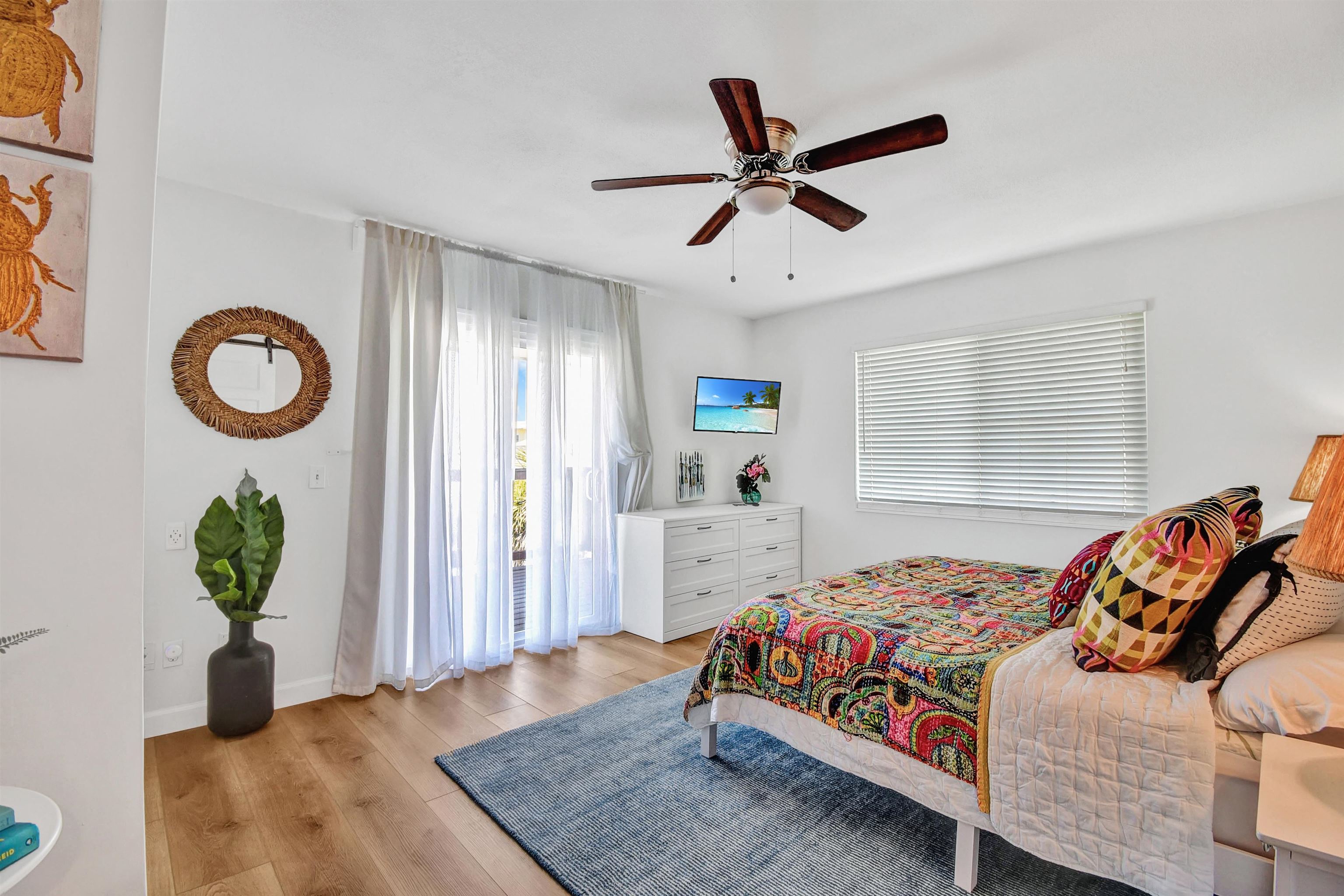 5703 Rudolph Avenue St. Augustine, FL 32080 - Photo 19 of 29 a bedroom with a bed and a chandelier