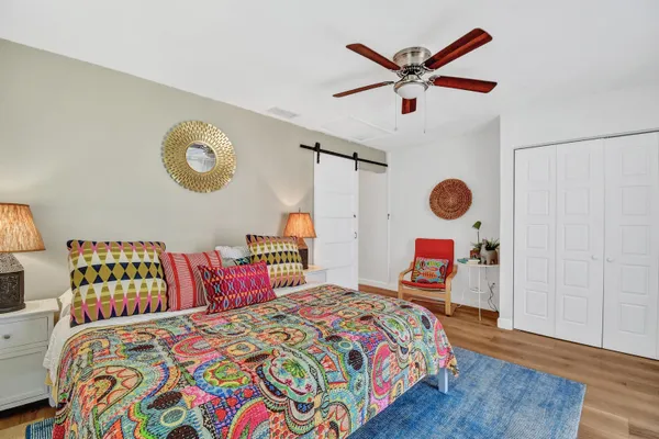 a bedroom with a bed and a chandelier