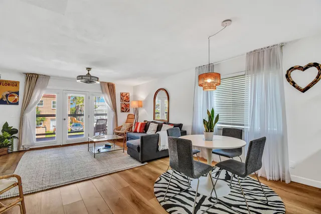 a living room with furniture a window and gym equipment
