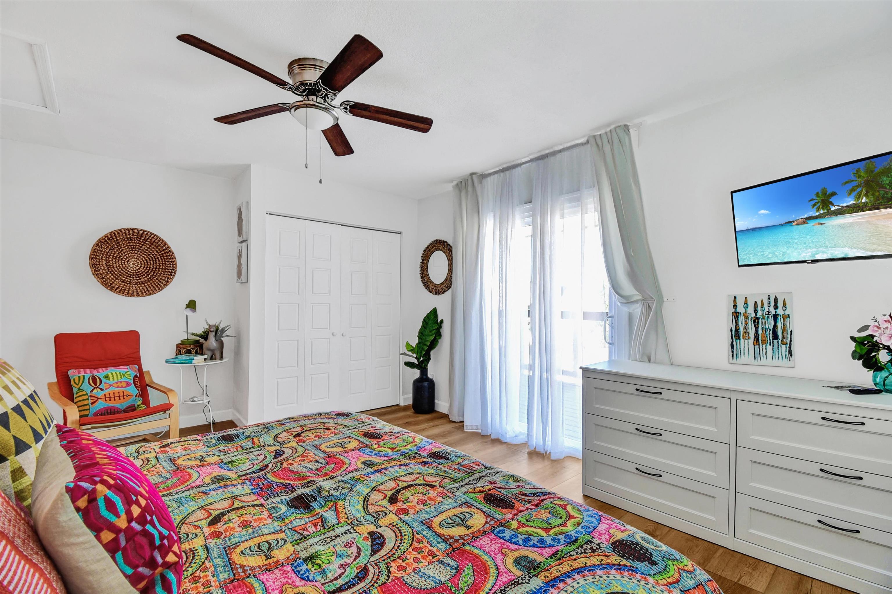 5703 Rudolph Avenue St. Augustine, FL 32080 - Photo 21 of 29 a bedroom with a bed and a chandelier