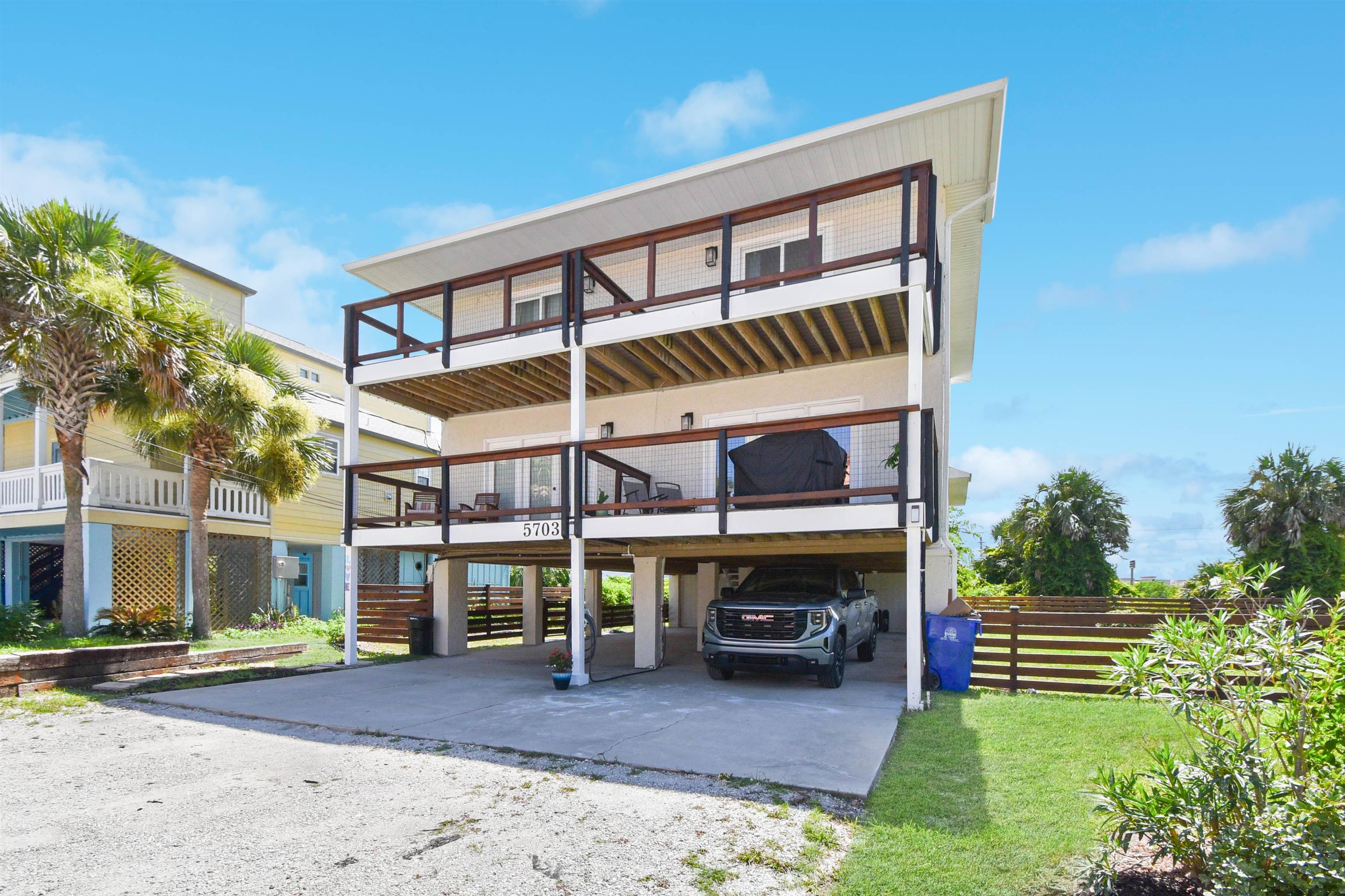 5703 Rudolph Avenue St. Augustine, FL 32080 - Photo 28 of 29 a view of a patio with a table and chairs under an umbrella