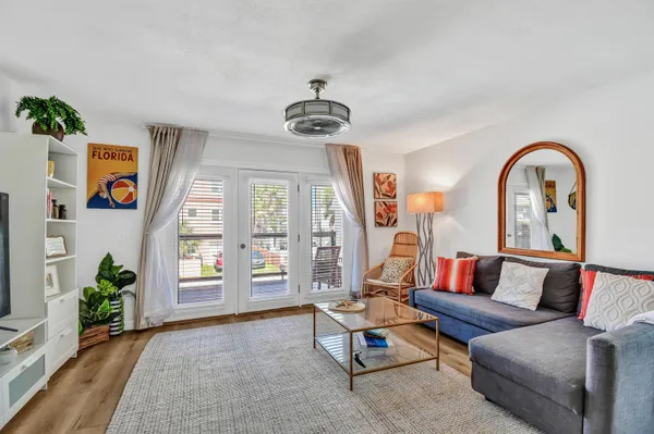 a living room with furniture and wooden floor