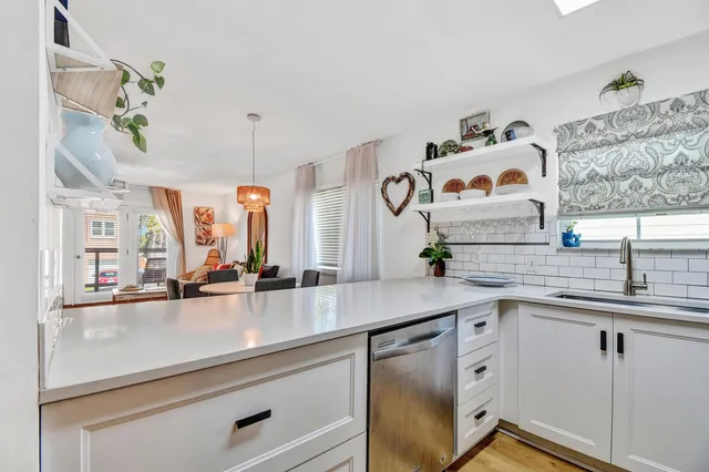 a kitchen with stainless steel appliances a sink and a window