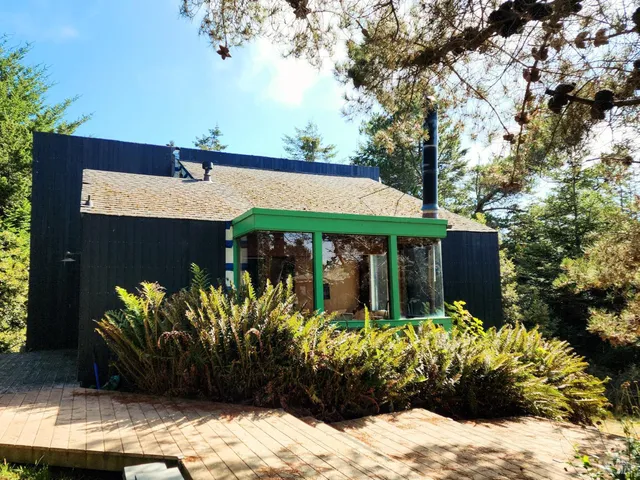 a view of a chairs and table in front of a house