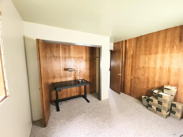 a spacious bedroom with a bed and a window