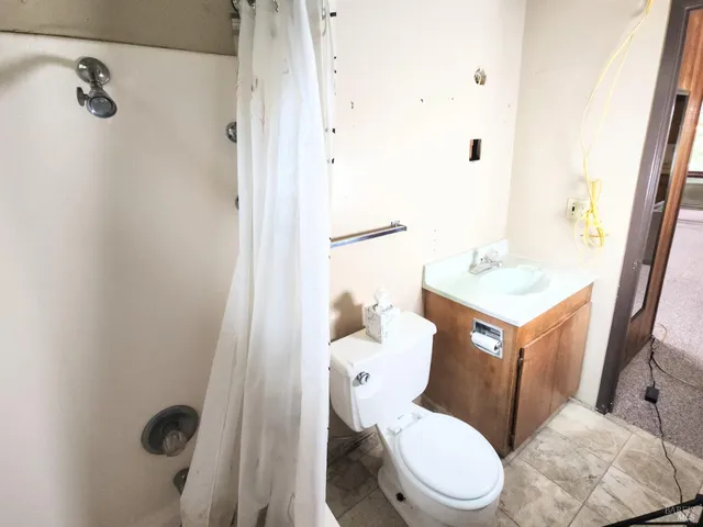 a white toilet sitting next to a bathroom sink