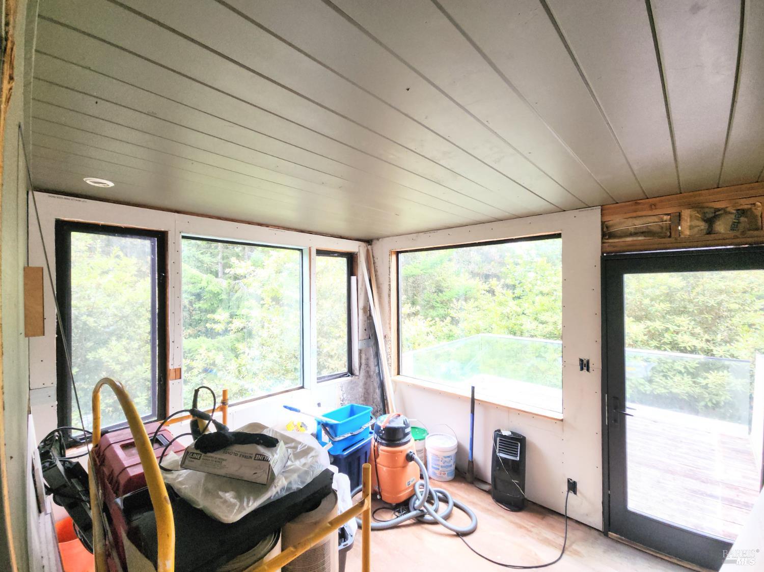 15551 Forest View Road Manchester, CA 95459 - Photo 18 of 53 a room with furniture a large window and a chandelier