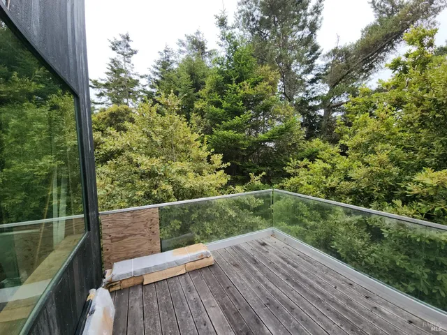 a view of a balcony with wooden floor
