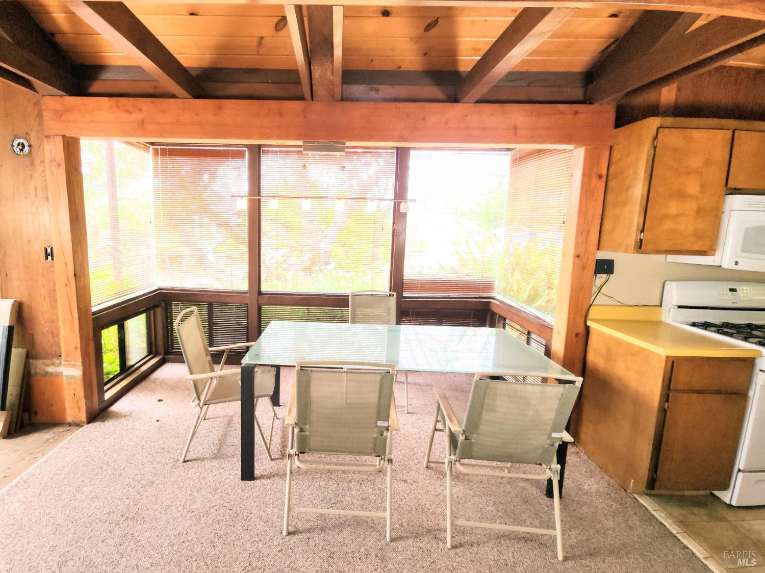 15551 Forest View Road Manchester, CA 95459 - Photo 4 of 53 a view of a dining room with furniture and a window