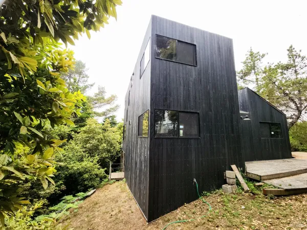 a vase of flowers sitting on a floor