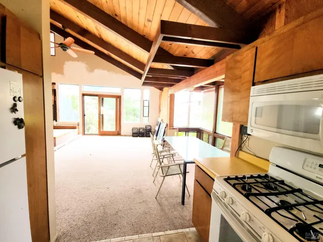 a kitchen with stainless steel appliances granite countertop a stove and cabinets