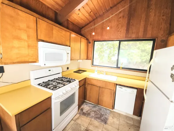 a kitchen with a stove a sink and a microwave