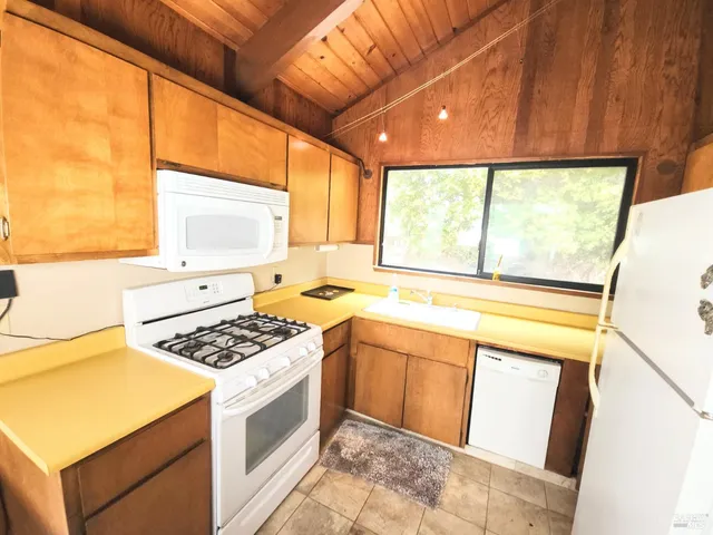 a kitchen with a stove a sink and a microwave