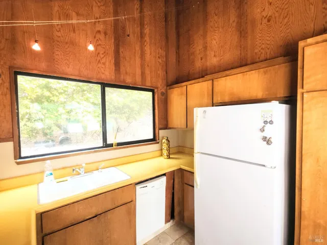 a kitchen with a refrigerator and a sink