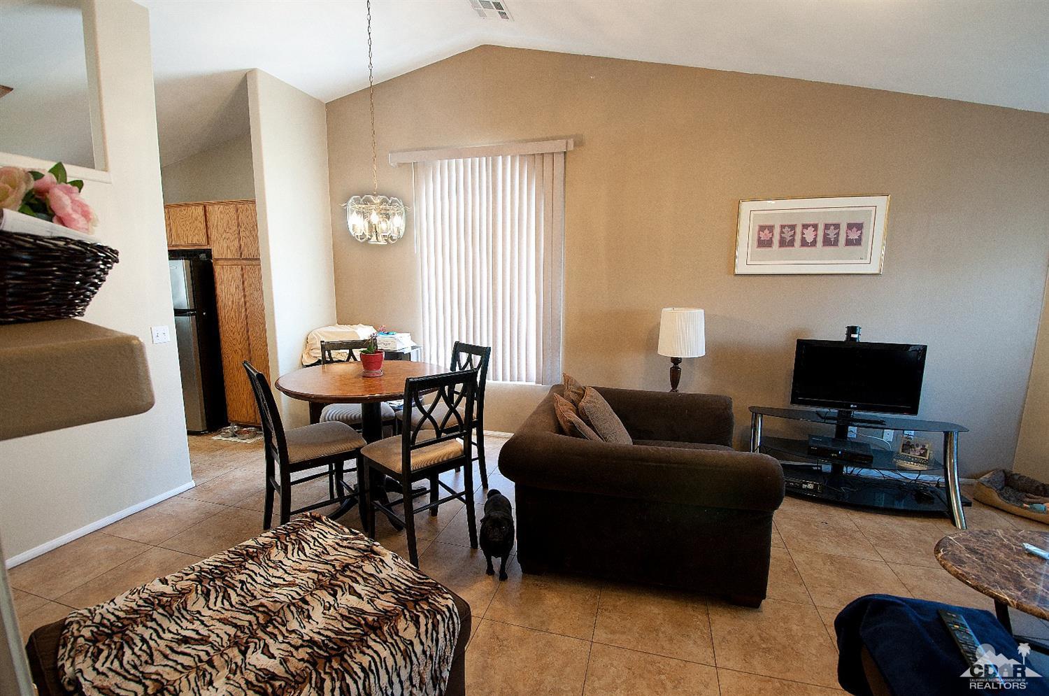 68874 Risueno Road Cathedral City, CA 92234 - Photo 3 of 8 a living room with furniture and a flat screen tv