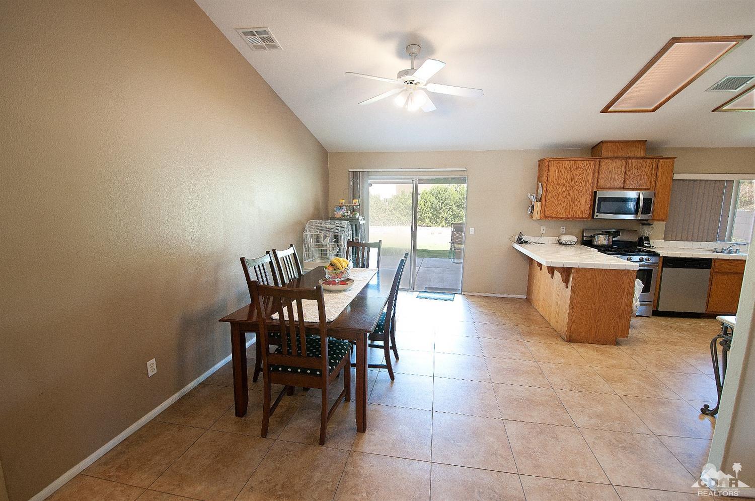 68874 Risueno Road Cathedral City, CA 92234 - Photo 6 of 8 a view of a dining room with furniture and a chandelier