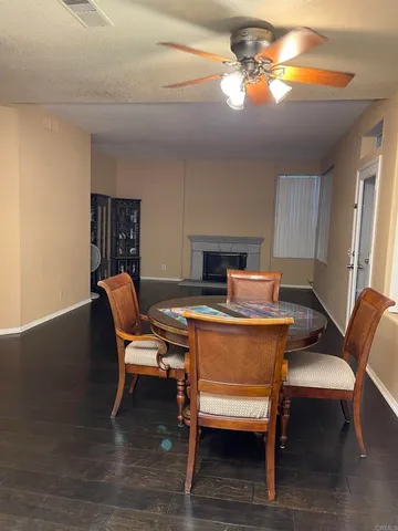 a backyard with table and chairs and potted plants