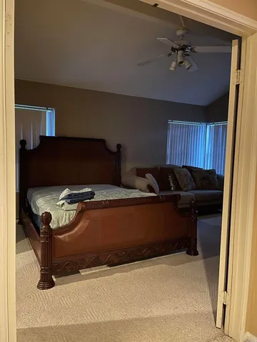 a kitchen with stainless steel appliances granite countertop a refrigerator a stove and a sink with wooden floors