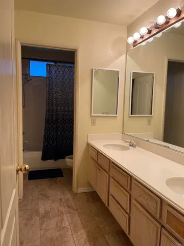 a living room with furniture a fireplace and a chandelier