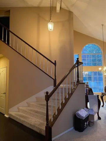 a view of empty room with fireplace and wooden floor