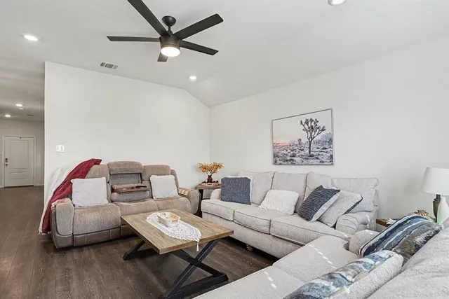 a kitchen with stainless steel appliances kitchen island granite countertop a kitchen island and chairs in it