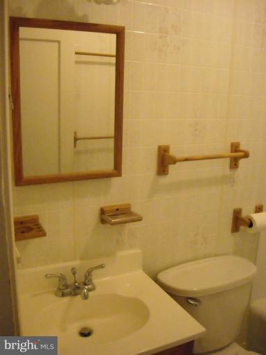 1501 Shawan Road Cockeysville, MD 21030 - Photo 8 of 24 a bathroom with a sink a toilet and shower