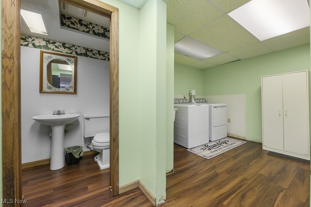 547 Lansing Road Akron, OH 44312 - Photo 41 of 50 Washroom with dark wood-style flooring, washer and dryer, and a paneled ceiling