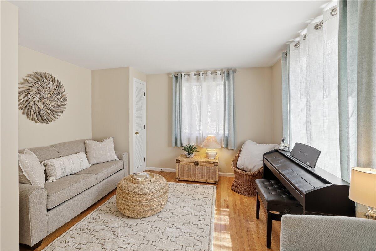 100 Mid-Iron Way, Unit 7027 Mashpee, MA 02649 - Photo 11 of 38 a living room with furniture and a potted plant