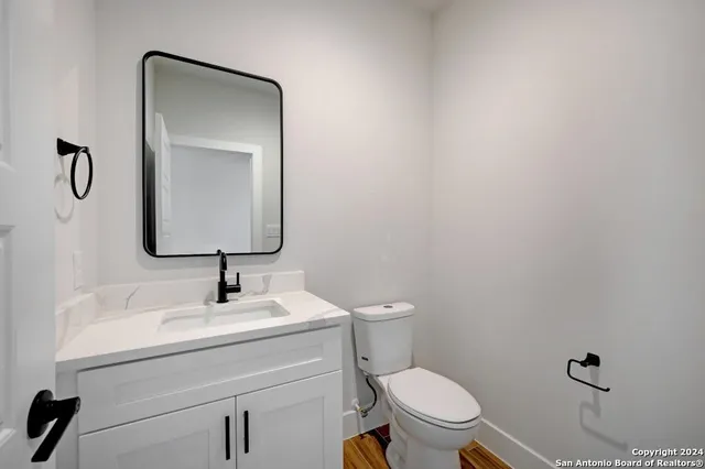 a bathroom with a toilet sink and mirror