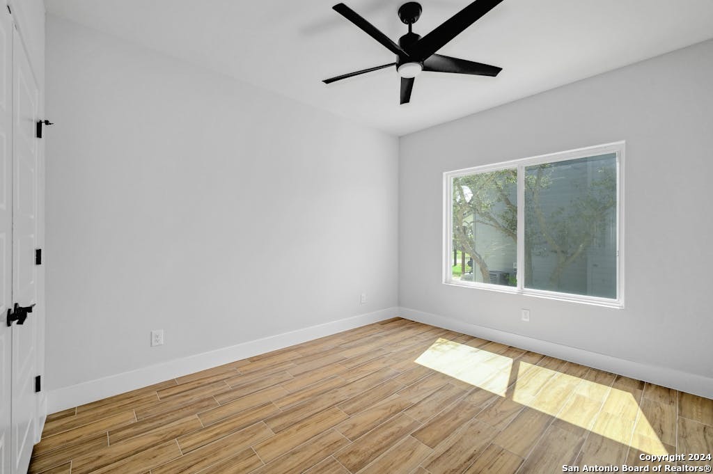 102 George Erath Blanco, TX 78606 - Photo 17 of 20 wooden floor in an empty room with a window