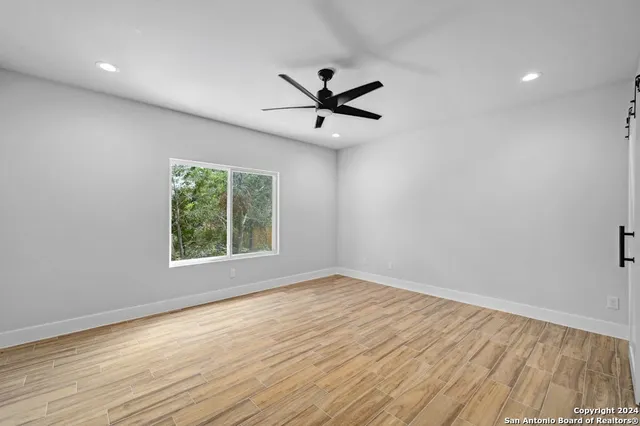wooden floor in an empty room with a window