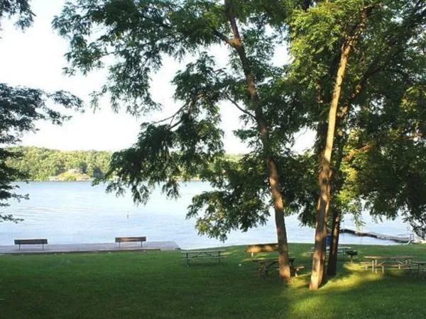a swimming pool with barbeque oven and outdoor seating