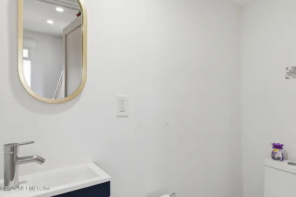 a bedroom with a bed and a flat tv screen