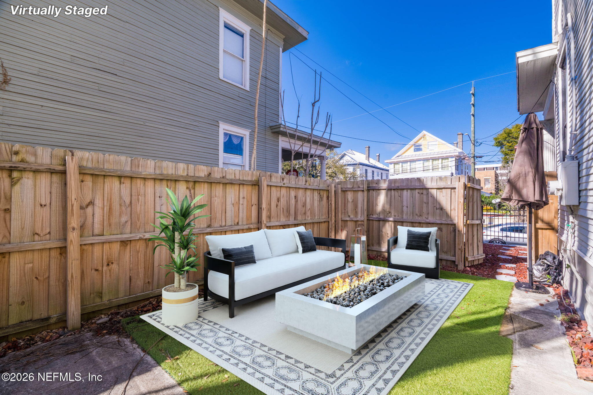 422 7th Street West Jacksonville, FL 32206 - Photo 52 of 71 a view of a patio with couches and a table and chairs with wooden floor