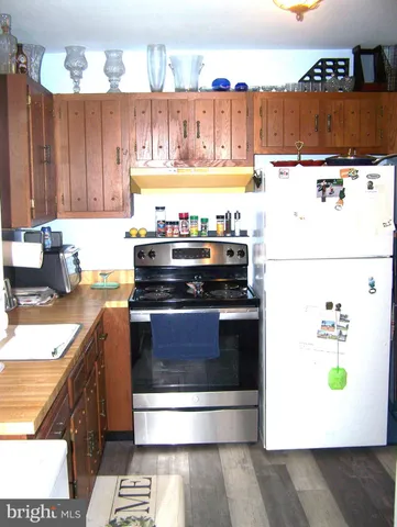 a kitchen with a stove and a refrigerator