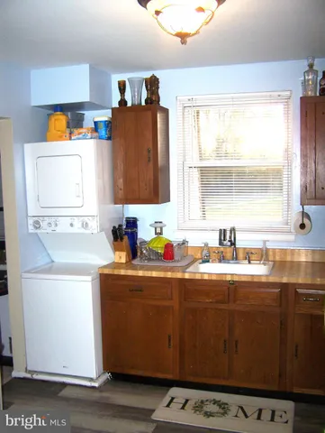 a kitchen with stainless steel appliances a sink a stove a refrigerator a counter top space and cabinets