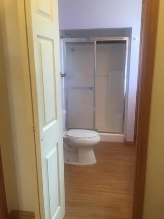 a bathroom with a toilet and a shower