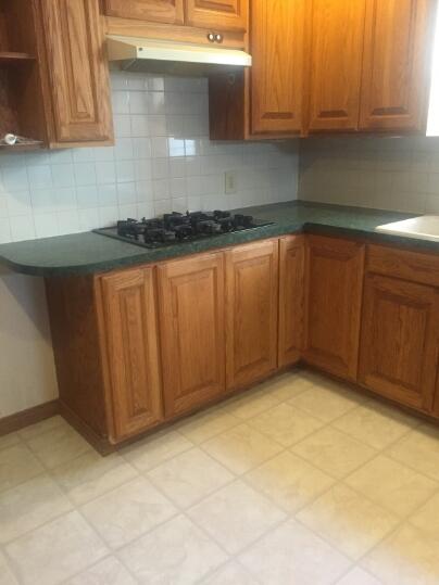 3407 29th Street Lubbock, TX 79410 - Photo 6 of 21 a kitchen with granite countertop a sink and cabinets