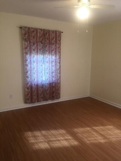 3407 29th Street Lubbock, TX 79410 - Photo 10 of 21 an empty room with wooden floor and windows