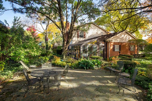 a backyard of a house with table and chairs