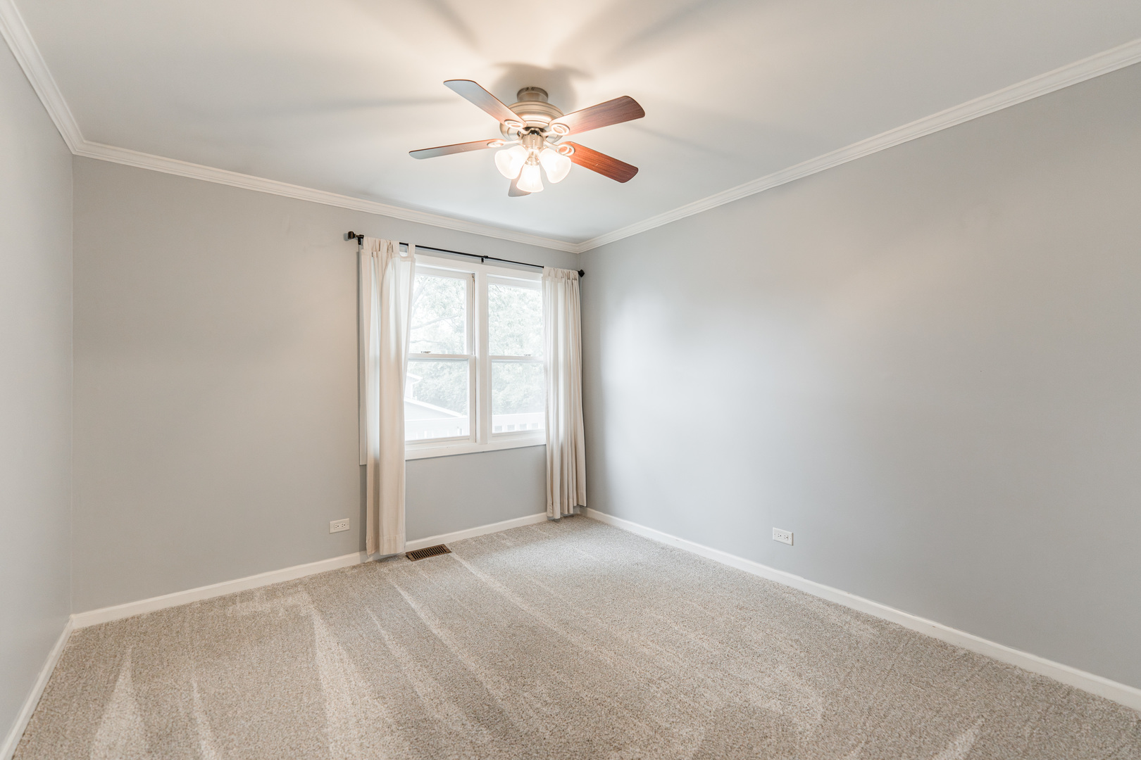 327 Georgetown Court, Unit B Bloomingdale, IL 60108 - Photo 14 of 25 an empty room with chandelier fan and windows