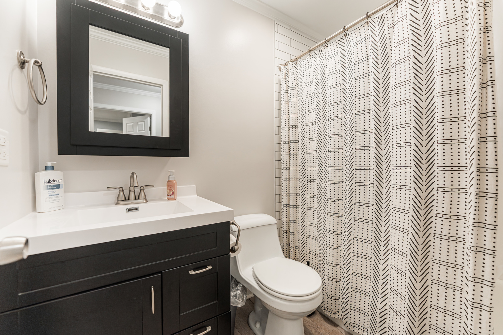 327 Georgetown Court, Unit B Bloomingdale, IL 60108 - Photo 16 of 25 a bathroom with a sink toilet and mirror