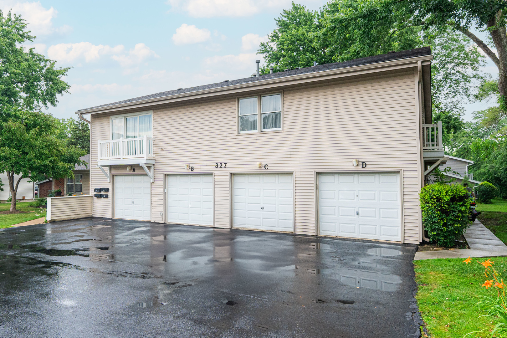327 Georgetown Court, Unit B Bloomingdale, IL 60108 - Photo 21 of 25 a view of a white house with a yard and garage