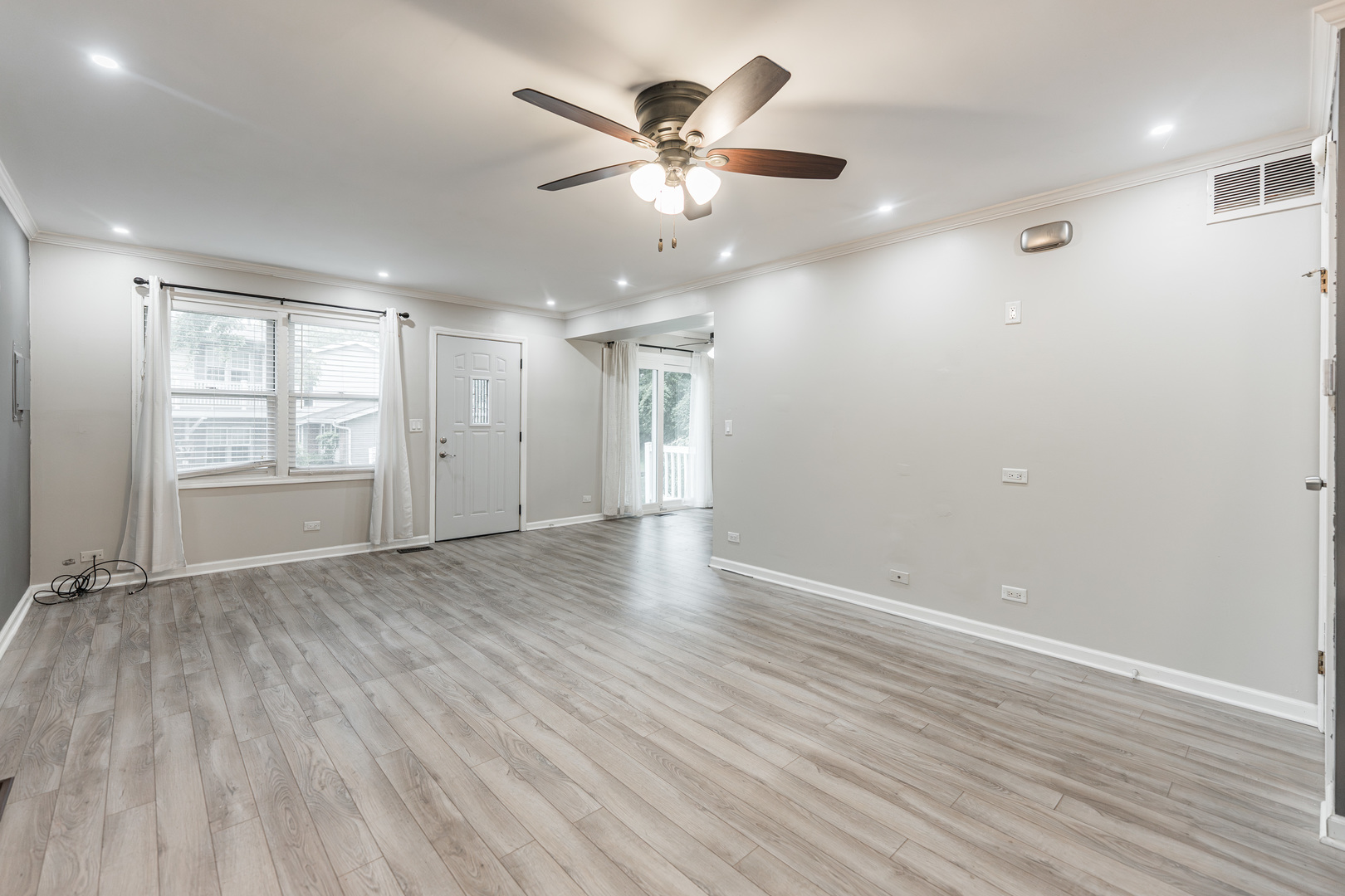 327 Georgetown Court, Unit B Bloomingdale, IL 60108 - Photo 4 of 25 an empty room with wooden floor and windows