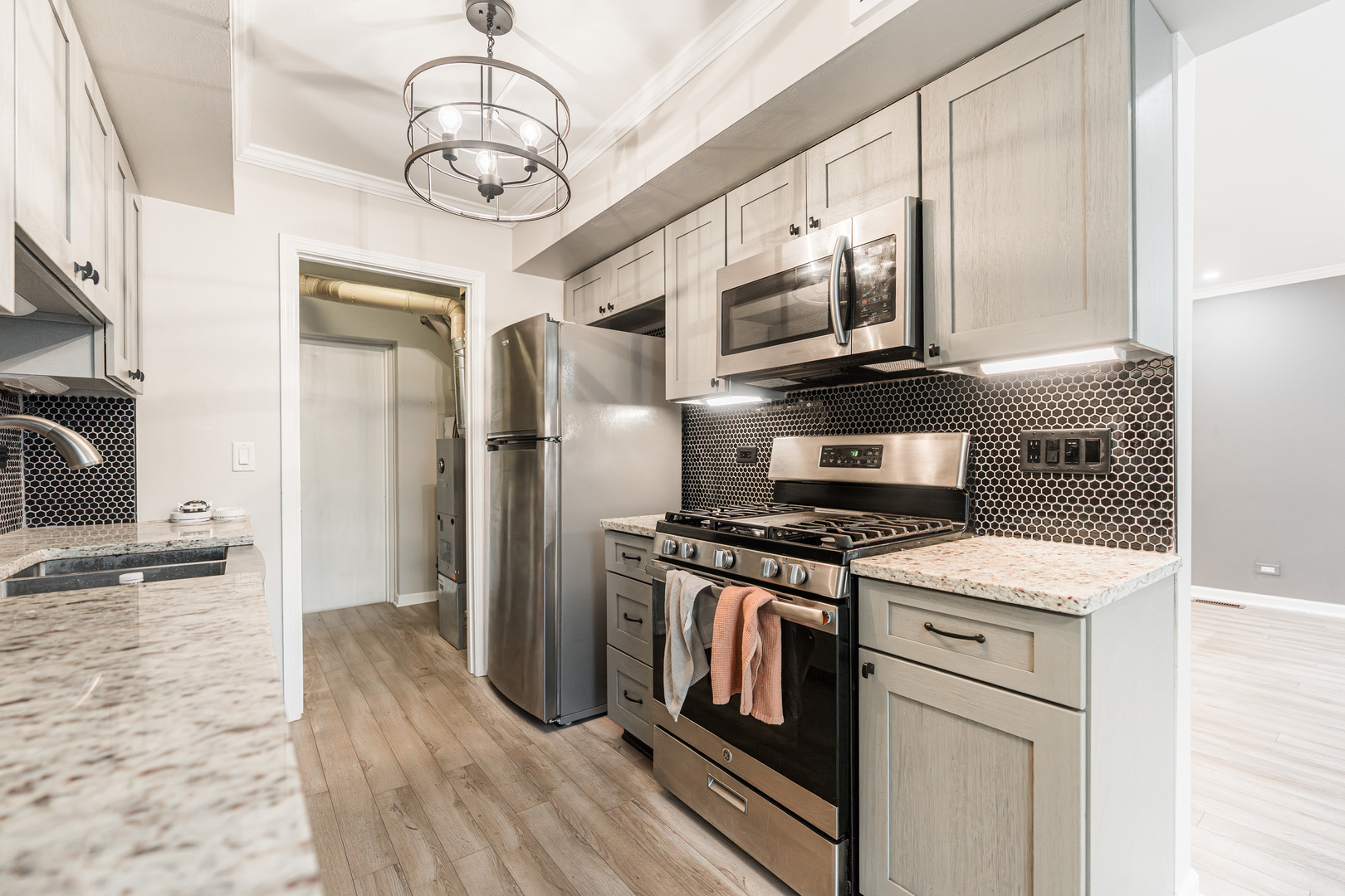 327 Georgetown Court, Unit B Bloomingdale, IL 60108 - Photo 7 of 25 a kitchen with stainless steel appliances granite countertop a stove and a refrigerator