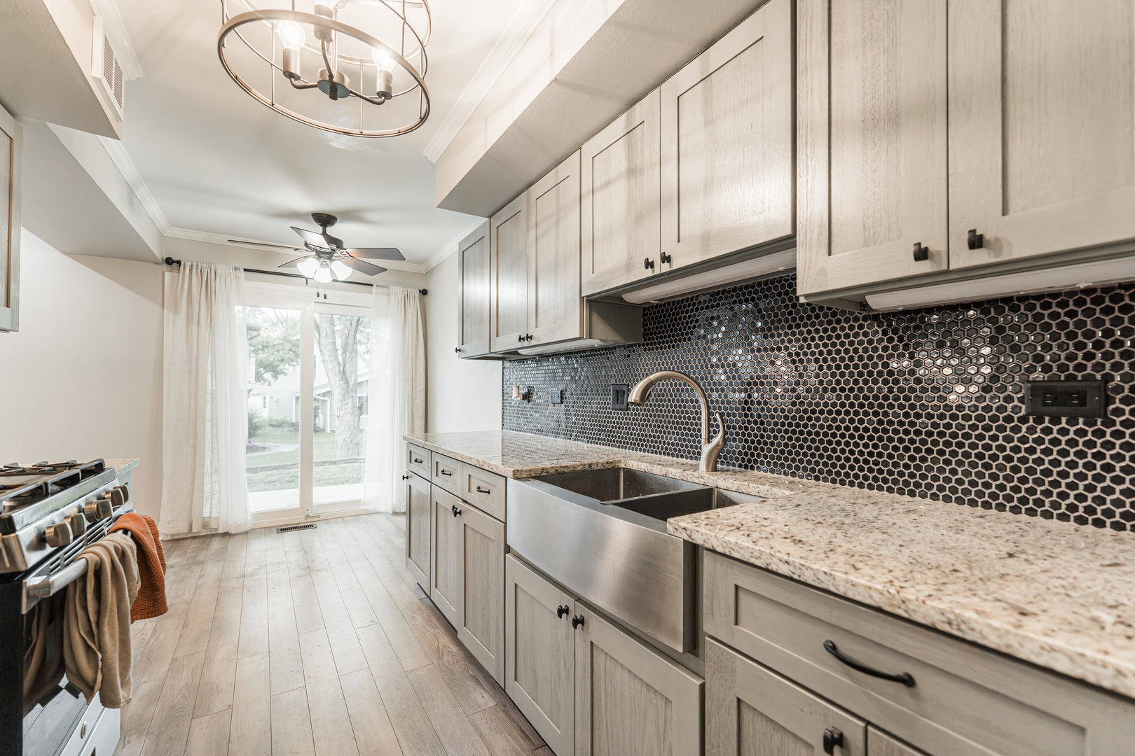 327 Georgetown Court, Unit B Bloomingdale, IL 60108 - Photo 9 of 25 a kitchen with stainless steel appliances granite countertop a sink stove and refrigerator